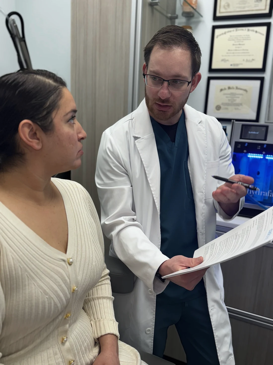 Samuel Khrapov, RN, consulting one-on-one with a patient at Drop of Paradise med spa in El Cerrito, CA